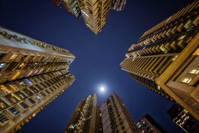 Low angle view of modern skyscraper at night