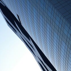 Low angle view of modern building against clear blue sky