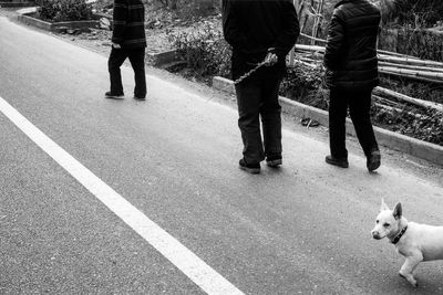 Low section of people standing on road