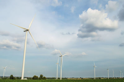 Windmill on field against sky