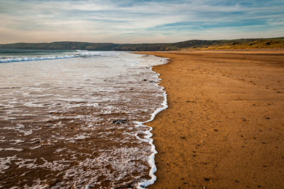 Scenic view of beach against sky