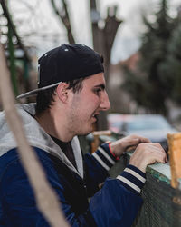 Portrait of young man looking away outdoors