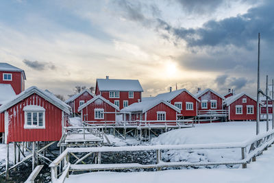 Houses by house against sky