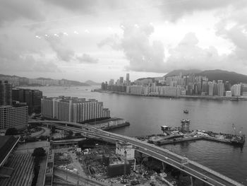 High angle view of river and buildings against sky