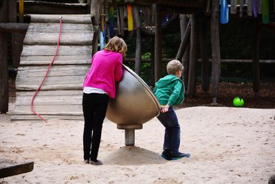 Rear view of women playing with umbrella