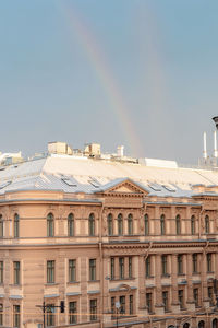 Double rainbow in sky after rain over rooftops, st. petersburg, russia
