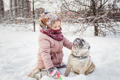 Rear view of a dog on snow covered field