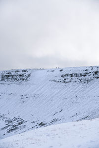 Scenic view of snow covered land against sky