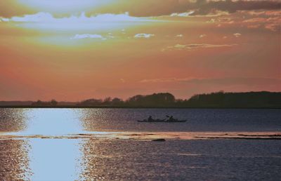 Scenic view of lake at sunset