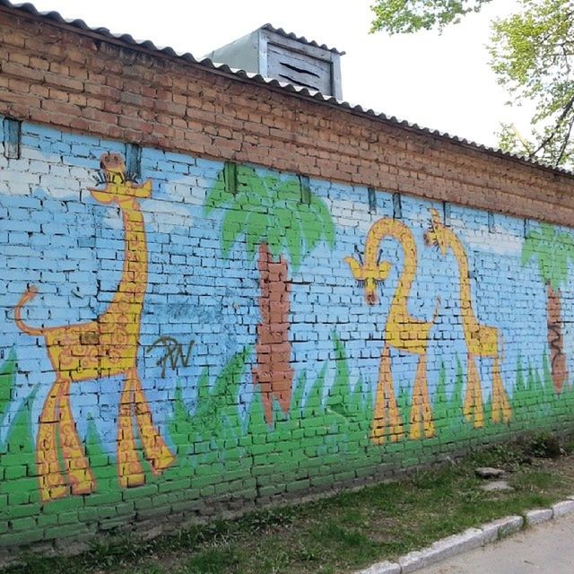 graffiti, art, art and craft, creativity, wall - building feature, built structure, architecture, street art, building exterior, text, multi colored, human representation, wall, western script, mural, day, communication, outdoors, brick wall