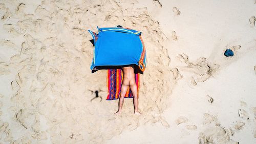 Rear view of person on sand at beach