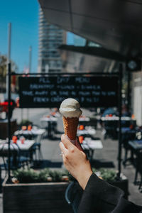 Cropped hand of woman holding ice cream cone