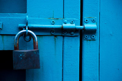 Close-up of padlock on blue door