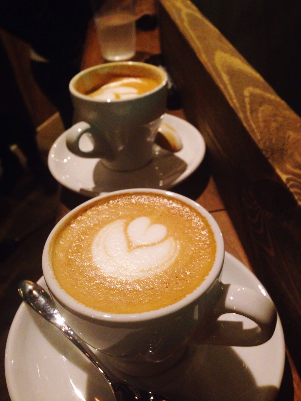 coffee cup, food and drink, drink, coffee - drink, indoors, refreshment, saucer, frothy drink, cappuccino, coffee, freshness, froth art, table, cup, still life, close-up, spoon, beverage, high angle view, latte