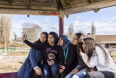 Teenage girls taking selfie