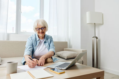 Young woman using laptop at home