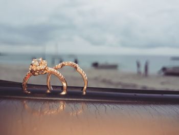 Close-up of wedding rings on the beach