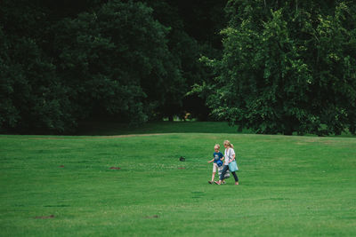 Full length of couple on field