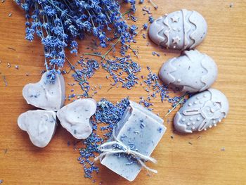 Directly above shot of homemade soaps with lavenders on table