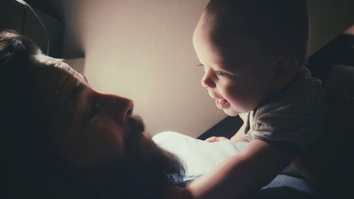 Close-up of father holding baby hand