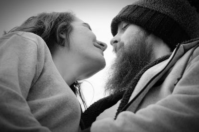 Close-up portrait of couple kissing outdoors