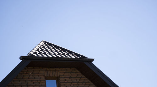 Low angle view of building against clear blue sky