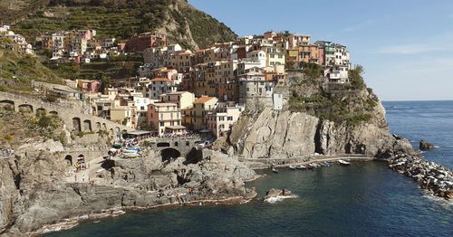 Scenic view of sea and buildings against sky