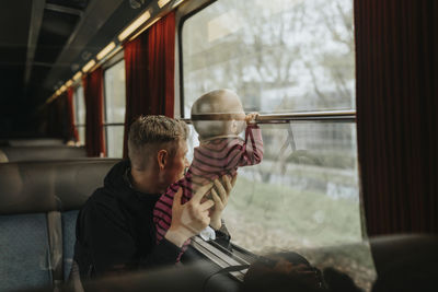 Father traveling with baby by train