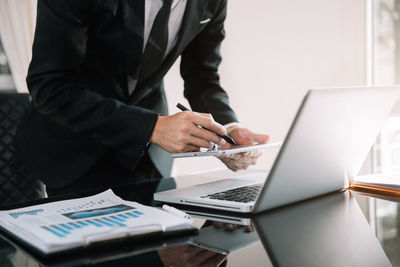 Rear view of man working on table