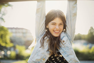 Portrait of happy teenager hanging at park