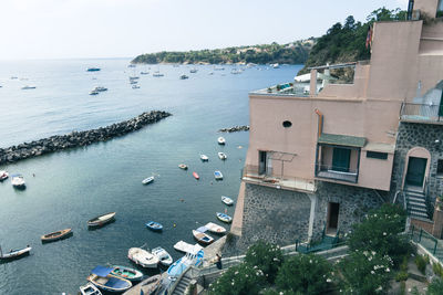 High angle view of sea and buildings against sky