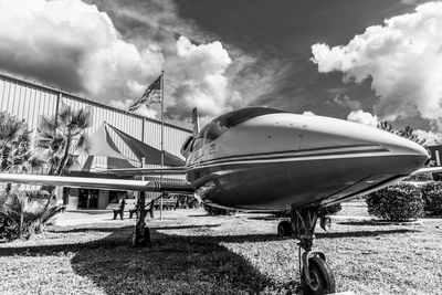 Airplane on field against sky