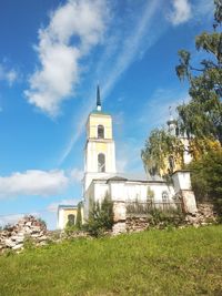 Church by building against sky