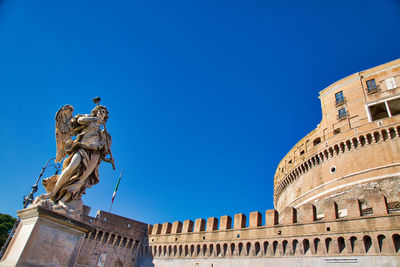 Low angle view of statue against blue sky