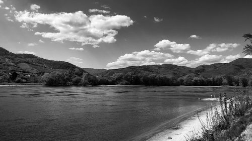 Scenic view of lake and mountains against sky