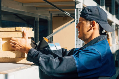 Side view of man working in workshop