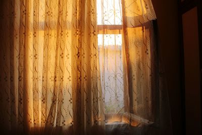 Close-up of curtain against window at home