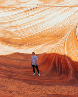 Front view of man walking at desert