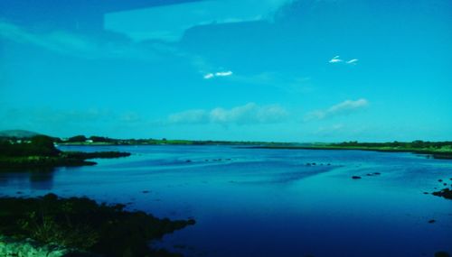 Scenic view of lake against blue sky