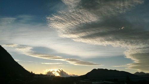 Low angle view of mountain against cloudy sky