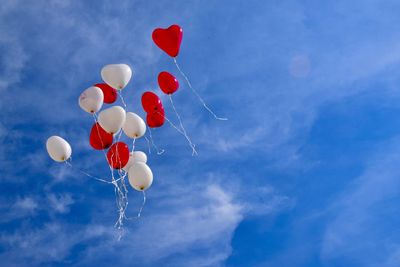 Low angle view of balloons against sky