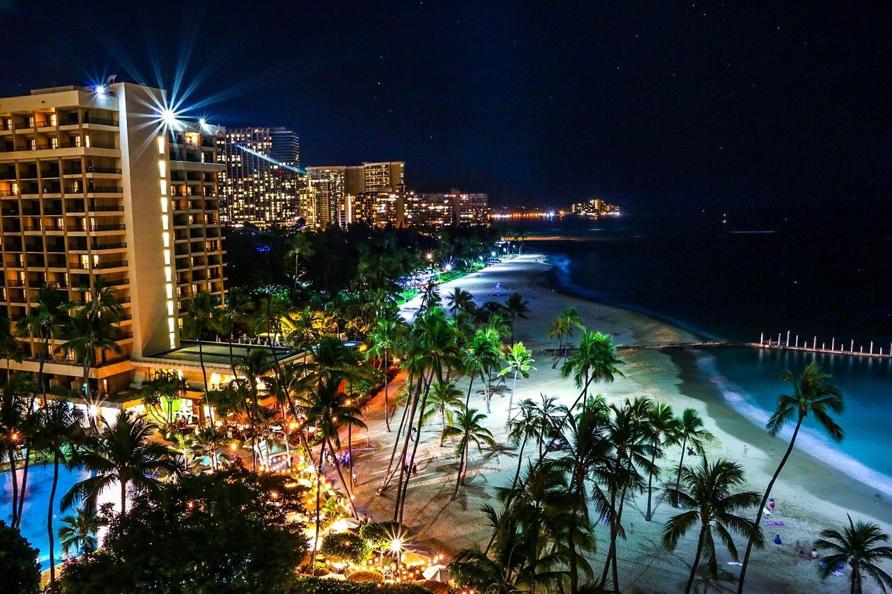 ILLUMINATED CITY AT WATERFRONT