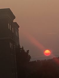 Low angle view of silhouette building against sky during sunset