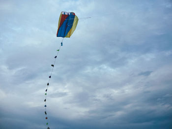 Low angle view of flags hanging against sky