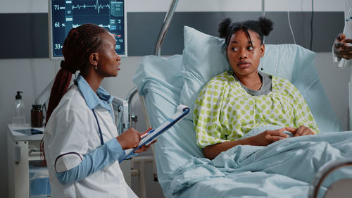 Doctor examining patient in hospital