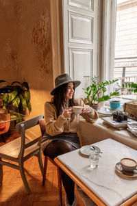 Attractive female with long hair sitting in a vintage cafe