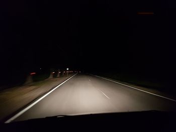 Blurred motion of car on road at night