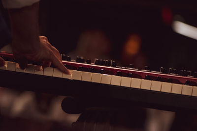 Cropped hand of person playing piano