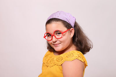 Portrait of smiling girl against white background