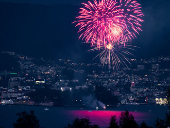 Firework display over city at night